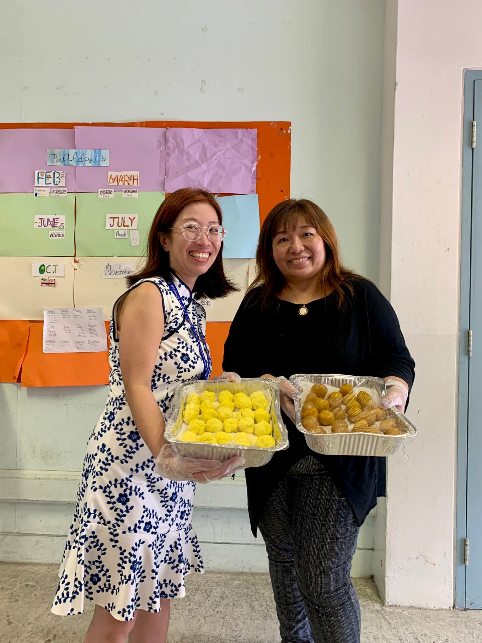 Two parents posing with Dough and Filling for our Mooncake Festival celebration